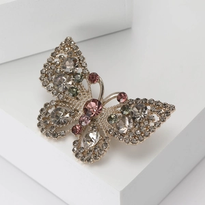 Exquisite hollow butterfly brooch with colorful rhinestones and crystals on white stage