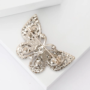 Elegant hollow butterfly brooch in gold alloy with intricate openwork back details