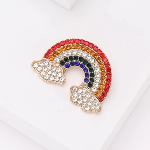 Close-up of rainbow crystal brooch with gold alloy base and colorful sparkling rhinestones