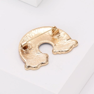 Exquisite golden rainbow brooch back view with secure safety pin clasp on white background