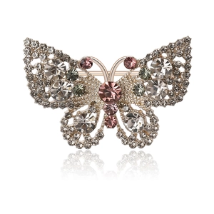 Elegant cutout butterfly brooch with colorful rhinestones on a white reflective base