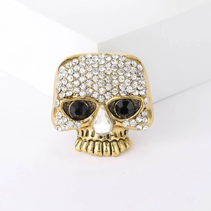 Gothic gold skull brooch with sparkling white rhinestones and black crystal eyes