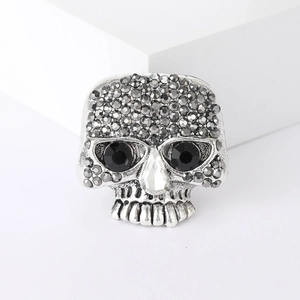 Gothic skull brooch with grey rhinestones and black eyes on white geometric cubes