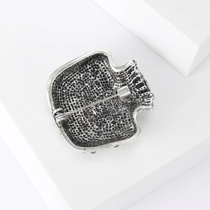 Detailed back view of vintage silver brooch showing the secure pin fastener and metal texture