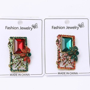 Detailed macro view of vintage baroque brooches with red and blue crystals in gold finish