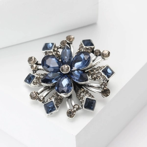 Elegant vintage silver flower brooch with deep blue crystals and champagne rhinestones
