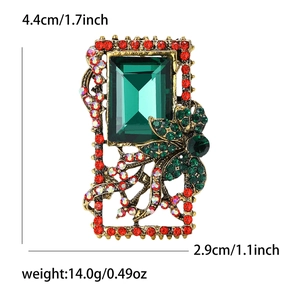 Baroque vintage brooch with emerald green crystal and red rhinestones on bronze base