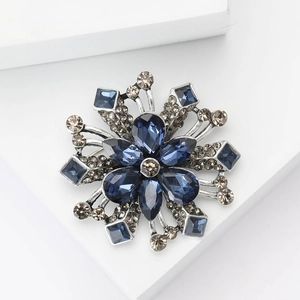 Elegant flower brooch with deep blue crystals and champagne rhinestones on silver base