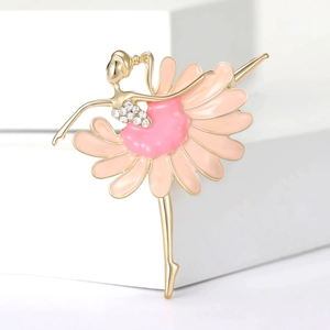 Detailed close-up of a golden ballerina brooch with pink enamel petals and rhinestones
