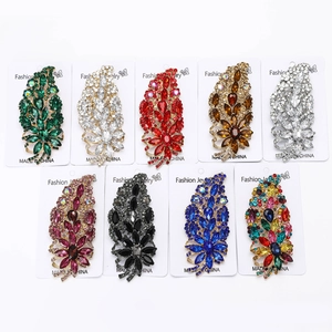 Macro detail of alloy flower brooches with multifaceted crystal rhinestones on display cards