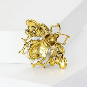 Vintage gold bee brooch with pearls and crystals shown from the back perspective