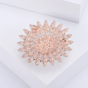Detail view of sunflower brooch back with rose gold plating and secure safety pin fastener