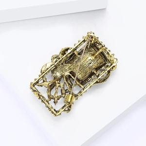 Detailed back view of vintage gold brooch showing secure safety pin clasp mechanism