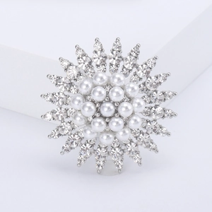 Elegant sunflower brooch featuring white pearls and sparkling rhinestones on silver metal