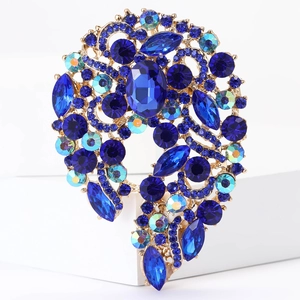 Detailed view of vintage alloy floral brooch with blue crystal and gold-tone finish