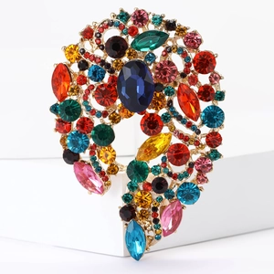 Detailed close-up of a vintage alloy brooch with colorful rhinestones and gold base
