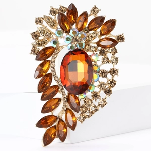 Detailed close-up of retro alloy brooch with amber crystal and champagne rhinestones