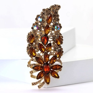 Detailed close-up of retro gold alloy brooch with amber crystals and sparkling rhinestones