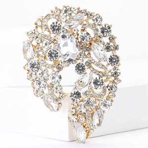 Macro shot of gold alloy brooch with clear crystals in a floral vine vintage design