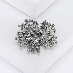 Detailed back view of vintage flower brooch showing secure pin and hollow metal base