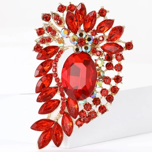 Vintage gold alloy brooch with large oval red crystal and sparkling diamond accents
