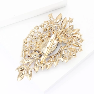 Detailed back view of vintage gold alloy brooch showing intricate hollow engraving and pin