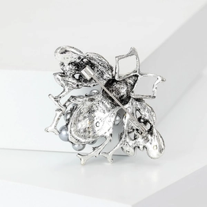 Detailed back view of vintage silver bee brooch showing needle pin mechanism and pearls
