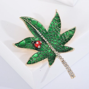 Green enamel leaf brooch with ladybug detail and sparkling rhinestones on golden base