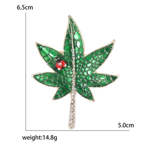 Sparkling green maple leaf brooch with ladybug detail and crystal rhinestones