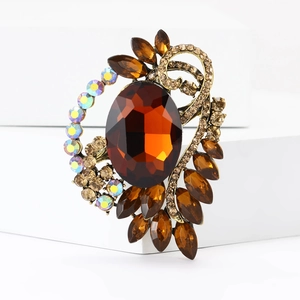 Detail of amber crystal brooch with rhinestones on vintage gold filigree base