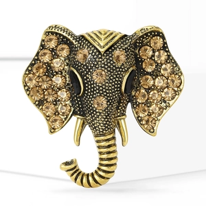 Vintage elephant head brooch in antique gold plating with sparkling amber rhinestones