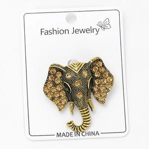 Detail of vintage elephant brooch featuring amber rhinestones on gold metal base