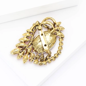 Detail view showing the secure vintage gold pin back of a rhinestone brooch