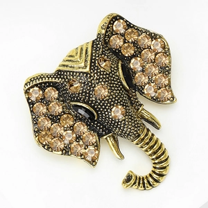 Macro shot of vintage elephant brooch detailing golden alloy and sparkling crystals