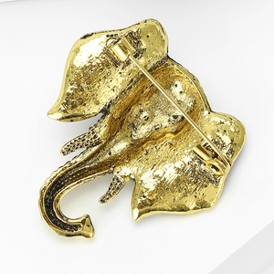 Detail view of the vintage elephant brooch back showing gold-tone texture and safety pin