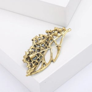 Detailed back view of a vintage gold leaf brooch showing secure pin clasp and hollow structure