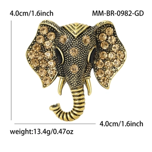 Vintage gold elephant brooch with brown rhinestones and ornate crystal detailing