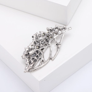 Detail of the vintage silver hollow leaf brooch back with secure safety pin clasp