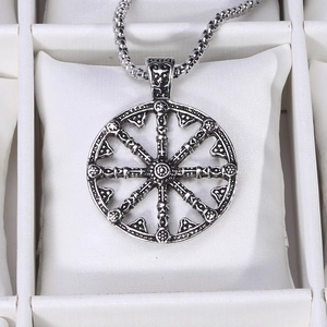 Détail du pendentif croix rétro en argent sur coussin de présentation en cuir blanc