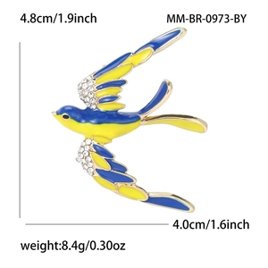 Broche hirondelle en émail bleu et jaune avec cristaux étincelants sur métal doré