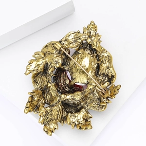 Detailed back view of vintage gold flower brooch showing pin clasp and metallic texture