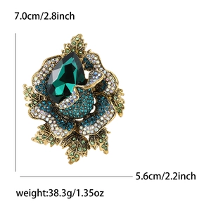 Vintage rose brooch with deep green crystal and blue rhinestones on gold alloy base