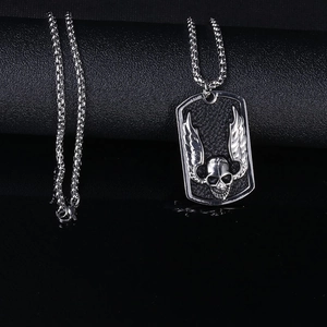 Gothic stainless steel skull necklace with wings pendant on a black leather background