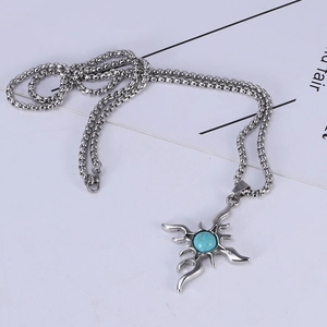 Macro shot of retro titanium steel necklace with sunburst pendant and turquoise center