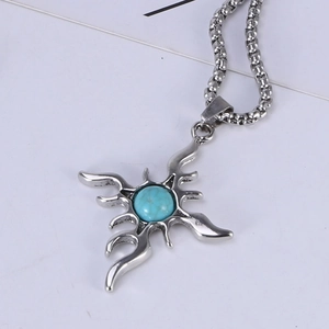 Macro view of retro titanium steel cross pendant with round turquoise stone and starburst design