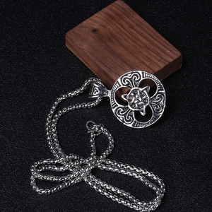 Detailed macro view of silver Celtic knot round pendant with durable box chain necklace