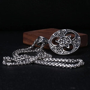 Macro view of vintage silver Celtic knot pendant with square box chain necklace