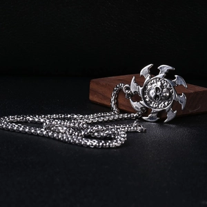 Détail macro du pendentif crâne punk avec bords tranchants sur chaîne argentée
