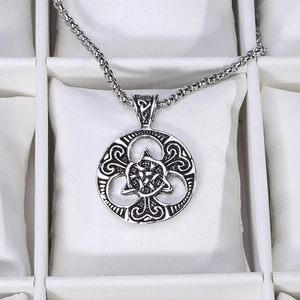 Detailed macro view of vintage silver Celtic Knot pendant on a sturdy square link chain