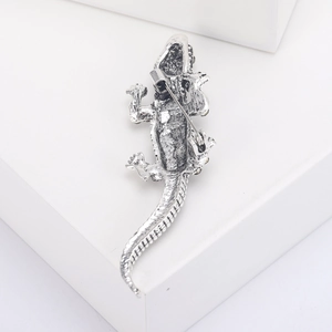 Detailed back view of vintage silver crocodile brooch with safety pin clasp and scales